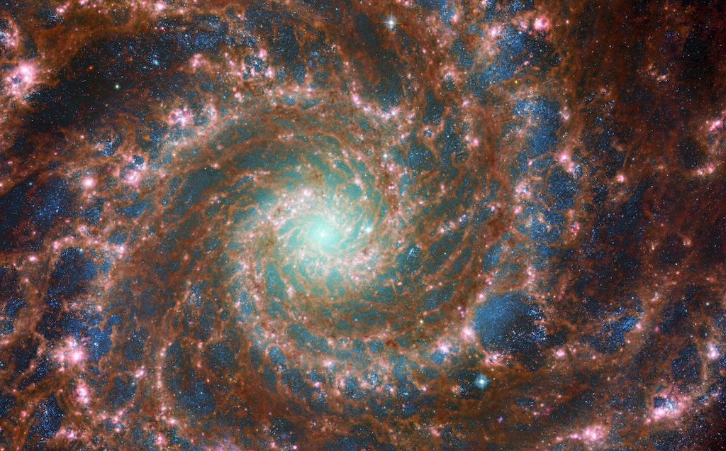 M74 [Phantom Galaxy] shines at its brightest in this combined optical/mid-infrared image.