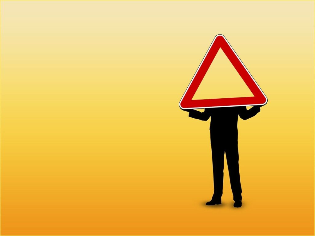 man holding warning-yield traffic sign
